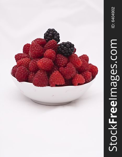 Bowl of raspberries and wild raspberries