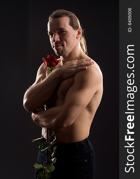 Standing romantic man with red rose. Standing romantic man with red rose