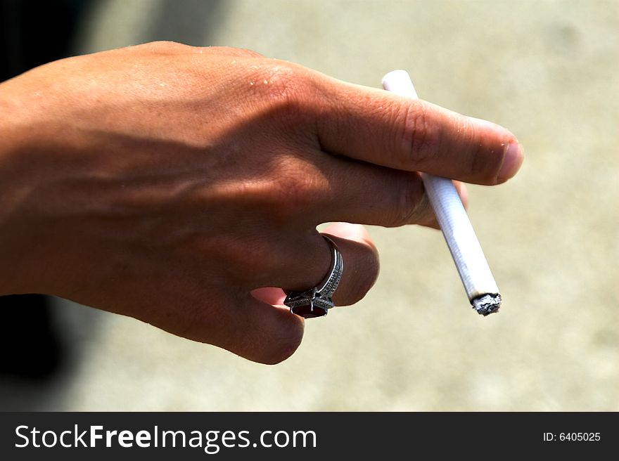 Picture of a hand holding a cigarette. Picture of a hand holding a cigarette