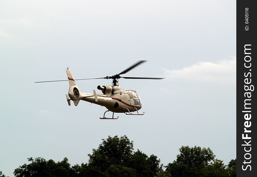 Civil helicopter hovering ready to climb and cruise