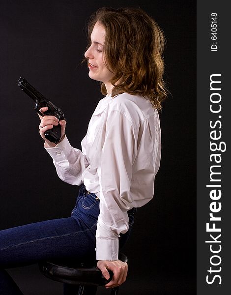 Woman on black handing gun. Woman on black handing gun