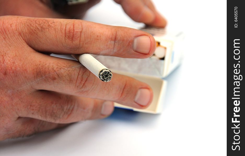 Shot of a hand holding a cigarette. Shot of a hand holding a cigarette