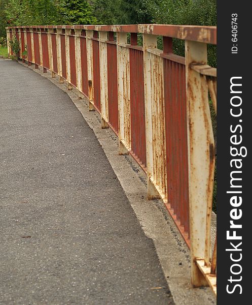 Railing on bridge with pavement