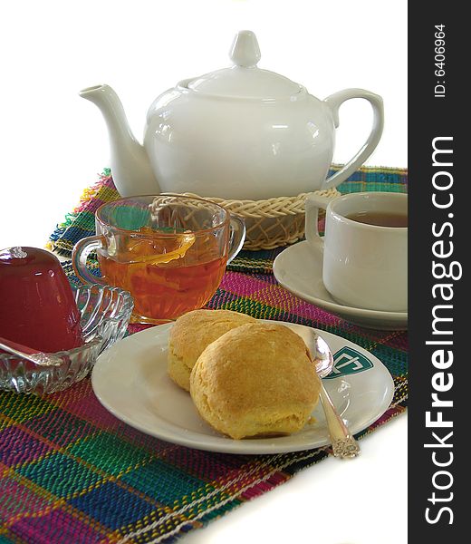 English breakfast with tea, scones, jelly and marmalade on a white background