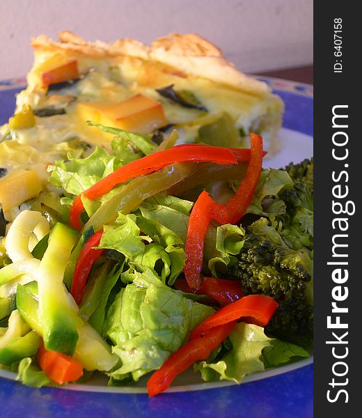 Green pumpkin pie with vegetarian salad in a restaurant table