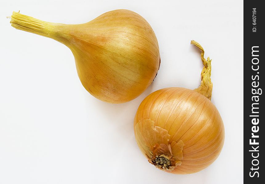 Two ripe onions on the white background
