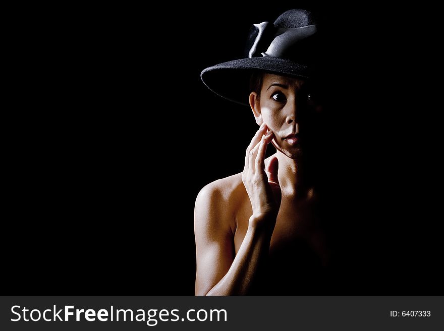 Woman In Shadow Wearing A Black Hat