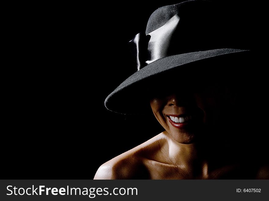 Mysterious shadowy woman in a big black hat. Mysterious shadowy woman in a big black hat