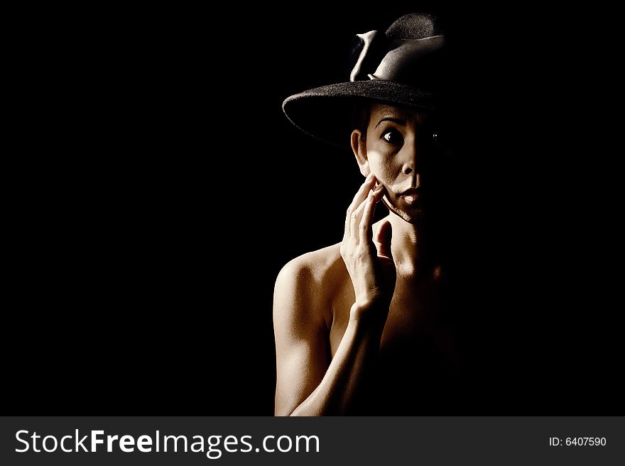 Woman in shadow wearing a black hat