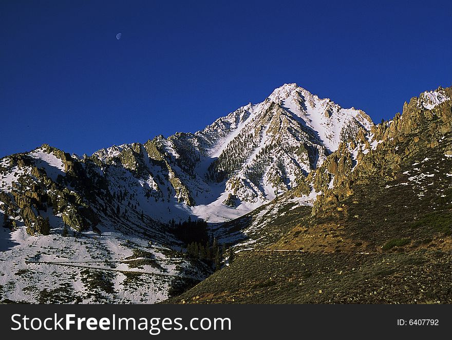 Snowy mountain peak with moon. Snowy mountain peak with moon