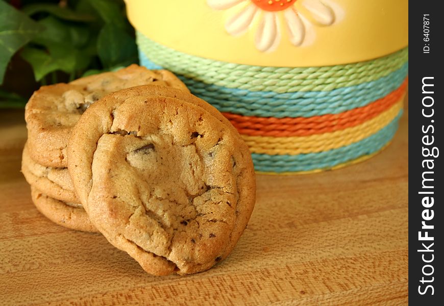Chocolate chip cookies against spring colors on a wood grain background