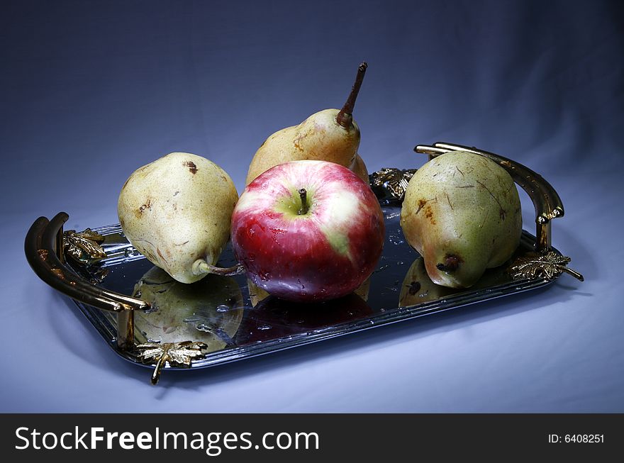 Apple and pears on tray with light brush