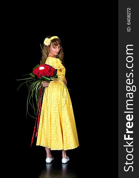 Portrait of a beautiful young bride showing her wedding bouquet of red and white roses on black background, studio shot. Portrait of a beautiful young bride showing her wedding bouquet of red and white roses on black background, studio shot