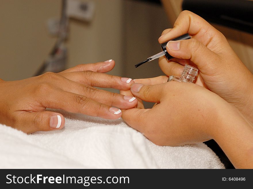 Manicurist works on customer nails. Manicurist works on customer nails