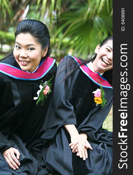 Gorgeous Asian university graduates celebrating their success.