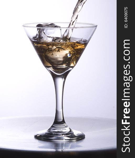 Stream of drink in a martini glass