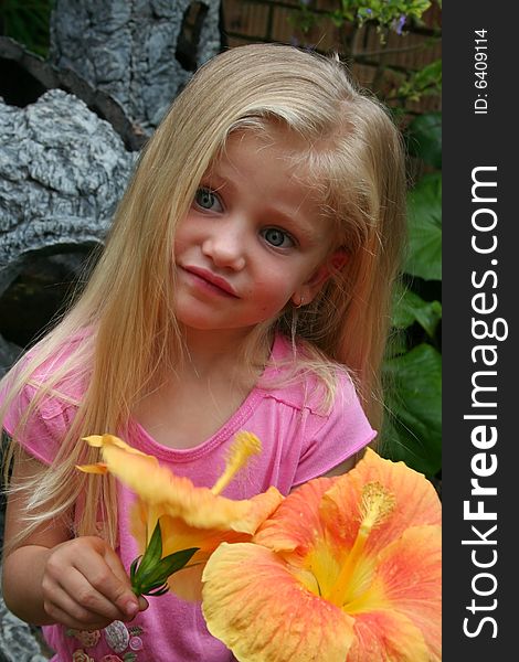 Cute little girl with blue eyes picking flowers. Cute little girl with blue eyes picking flowers