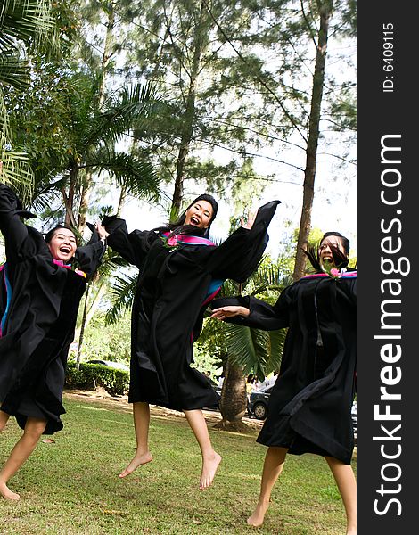 Gorgeous Asian university graduates celebrating their success.