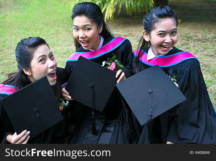 Gorgeous Asian university graduates celebrating their success.