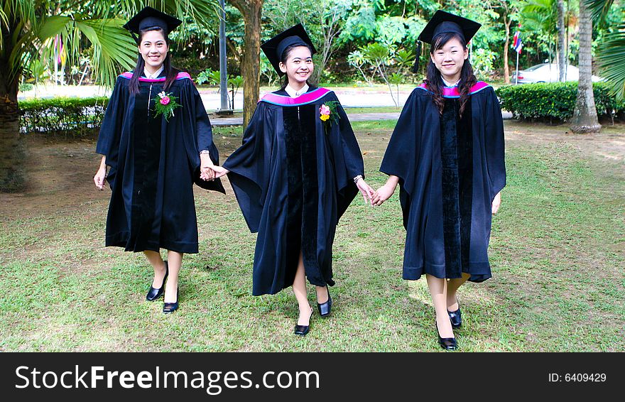 Gorgeous Asian university graduates celebrating their success.