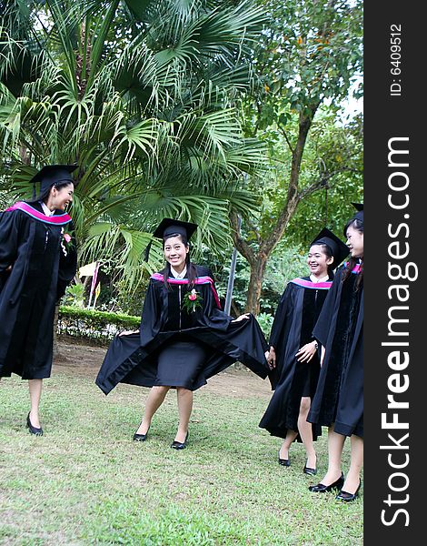 Gorgeous Asian university graduates celebrating their success.