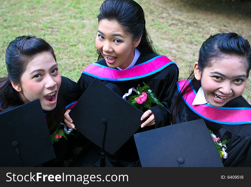 Gorgeous Asian university graduates celebrating their success.