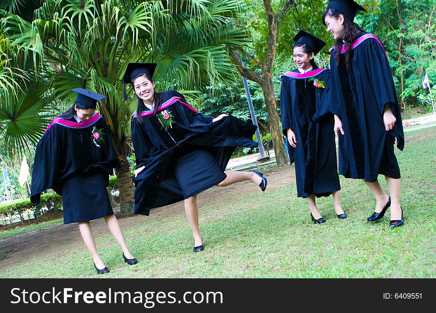 Gorgeous Asian university graduates celebrating their success.