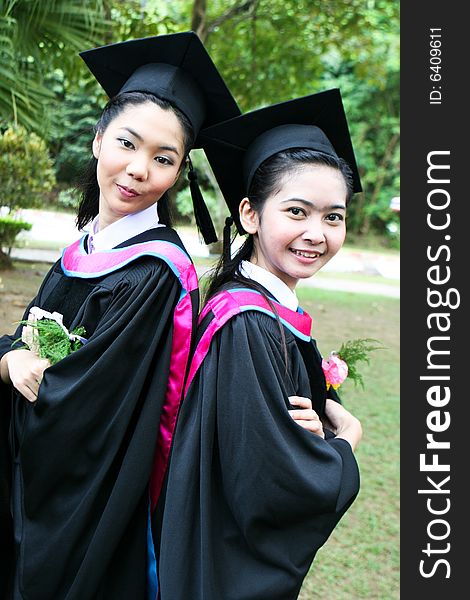 Gorgeous Asian university graduates celebrating their success.