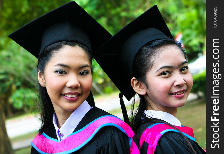 Gorgeous Asian university graduate celebrating her success.