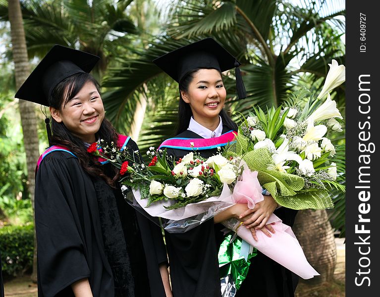 Gorgeous Asian university graduates celebrating their success.