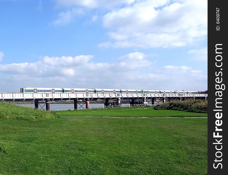 Landscape of commuter train crossing a river