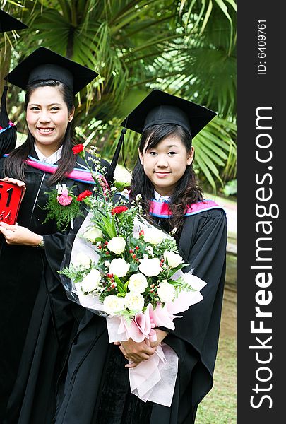 Gorgeous Asian university graduates celebrating their success.