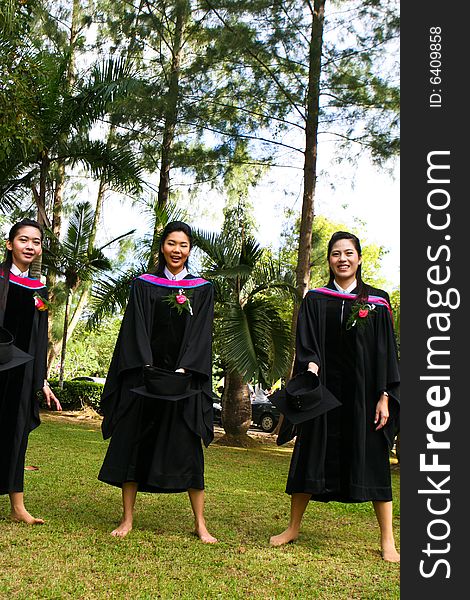 Gorgeous Asian university graduates celebrating their success.