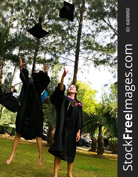 Gorgeous Asian university graduates celebrating their success.