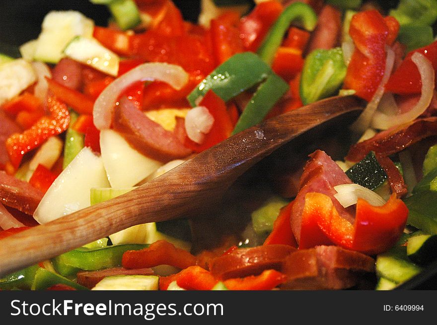 Mix of peppers, onion an sausage in a frying pan. Mix of peppers, onion an sausage in a frying pan