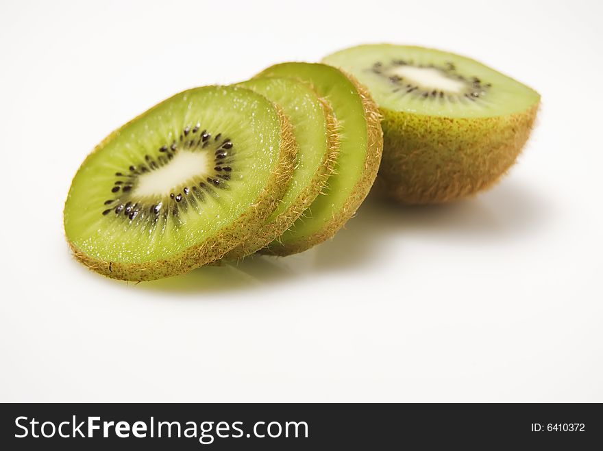 Slices of kiwi fruit on white background