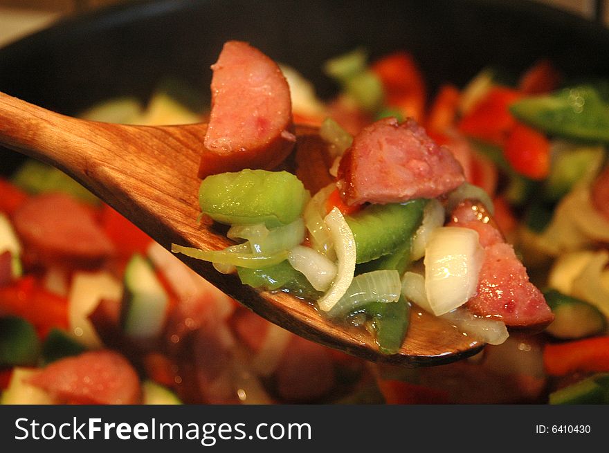 Mix of peppers, onion an sausage in a frying pan. Mix of peppers, onion an sausage in a frying pan