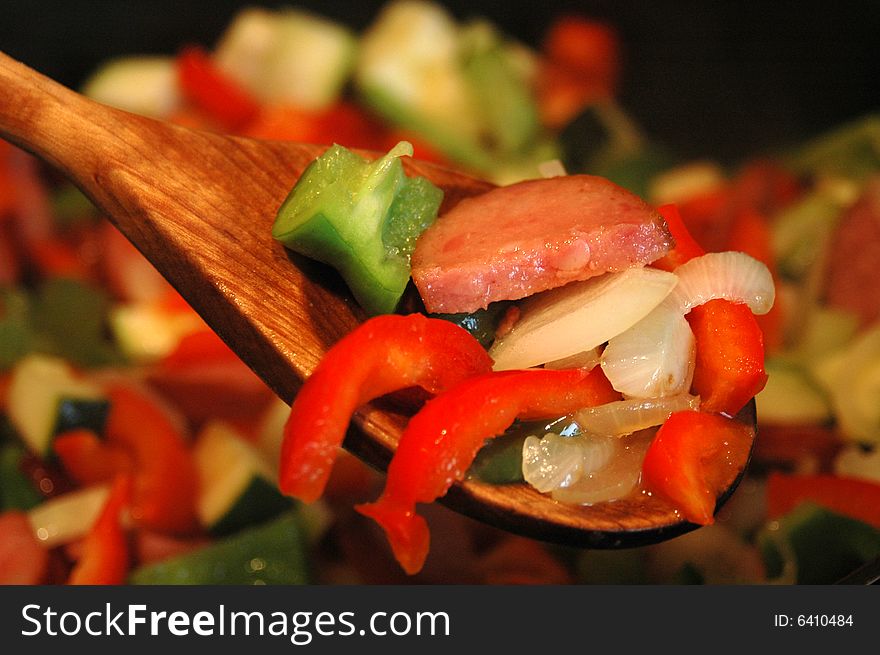 Mix of peppers, onion an sausage in a frying pan. Mix of peppers, onion an sausage in a frying pan