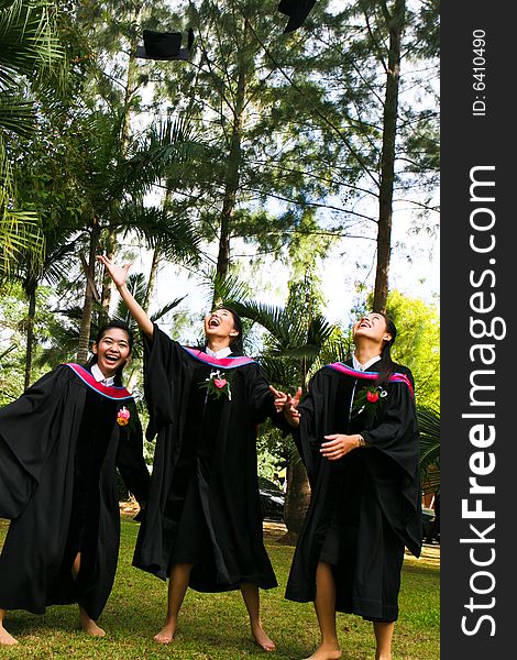 Gorgeous Asian university graduates celebrating their success.