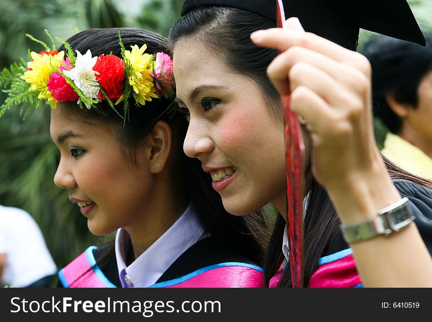 Gorgeous Asian university graduates celebrating their success.