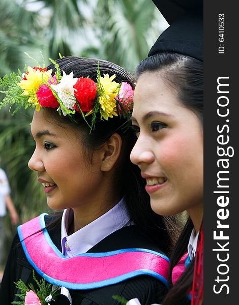 Gorgeous Asian university graduates celebrating their success.