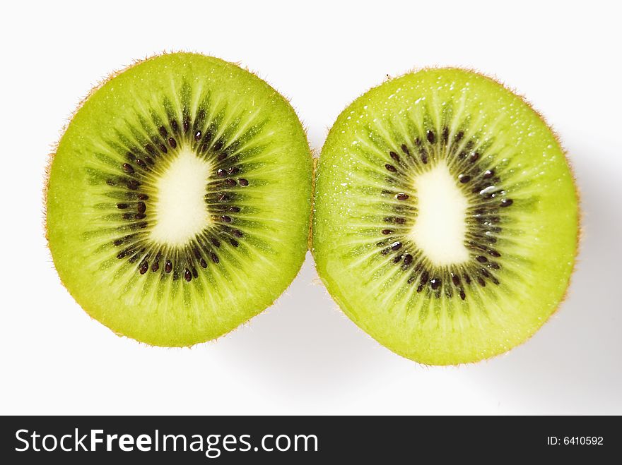 Cross-section of sliced kiwi fruit on white background