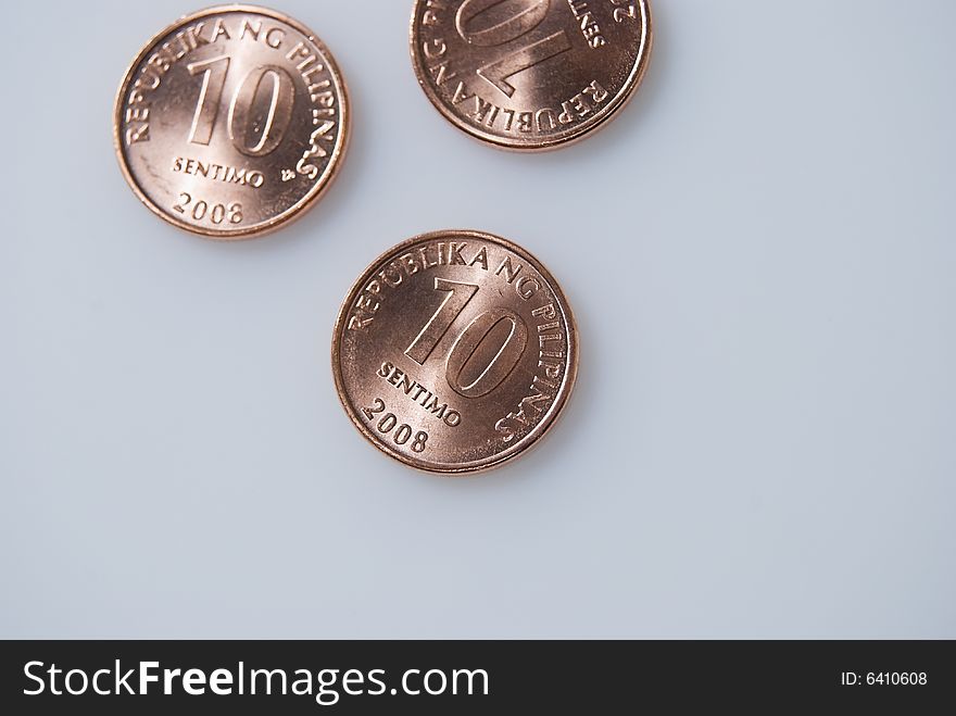 Ten-centavo Philippine coins on white background