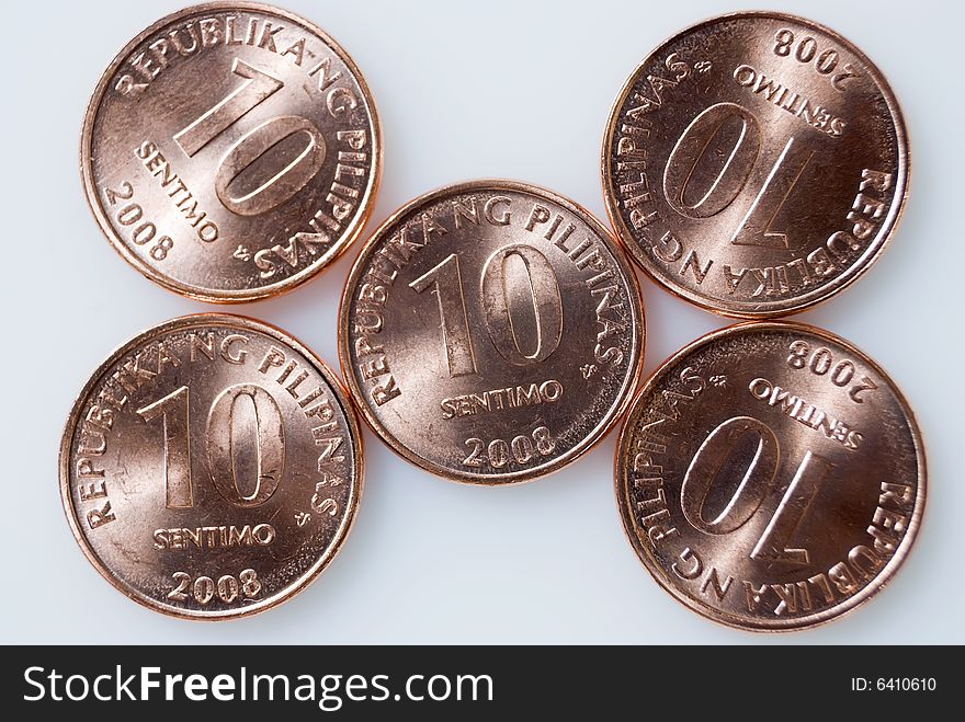 Ten-centavo Philippine coins on white background