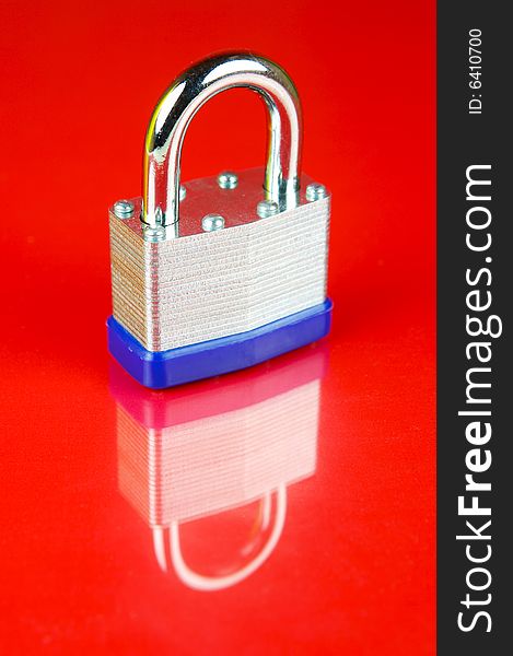 A padlock isolated against a red background