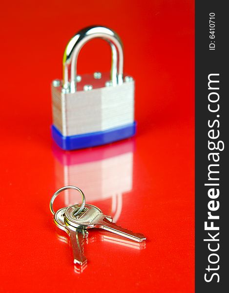 A padlock isolated against a red background