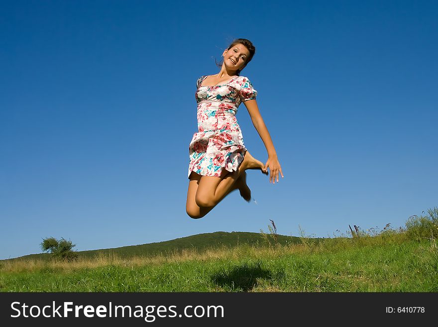 Girl jumps on the grass