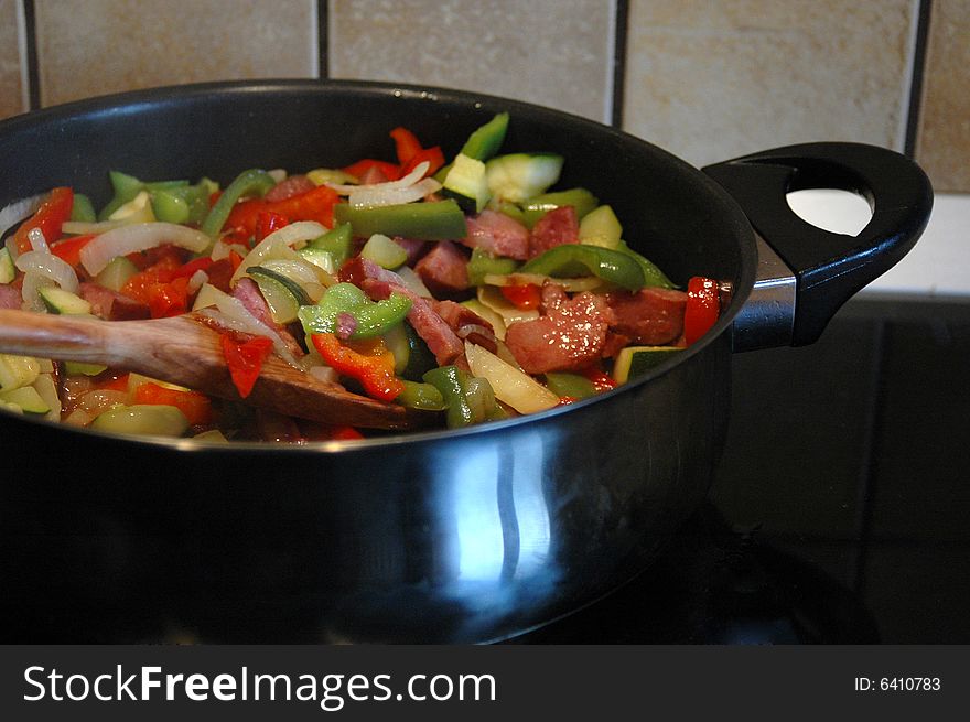 Mix of peppers, onion an sausage in a frying pan. Mix of peppers, onion an sausage in a frying pan