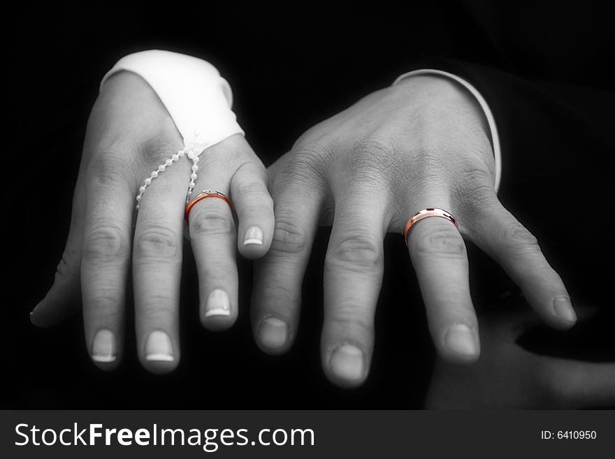 Color gold rings on the hands. Black and white photo