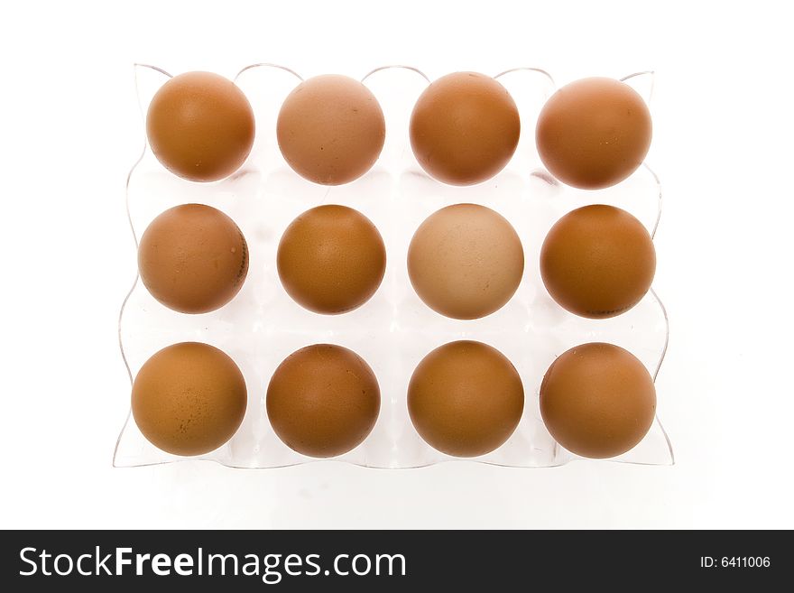 Eggs in container on white ground